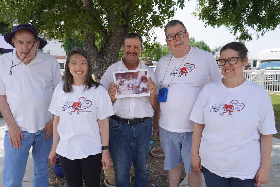 Volunteers serving hot meals at a food distribution event.